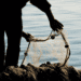 silhouette of man adjusting fishing net